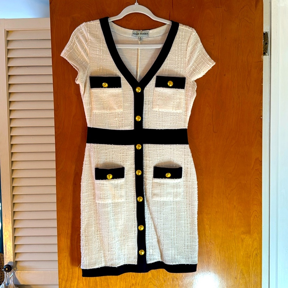 Cream dress with black trim and gold buttons
